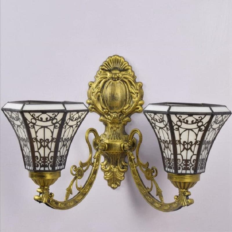 Decorative Retro Revival wall lamp with ornate bronze backplate