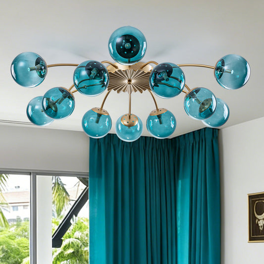 Industrial chic 12-light semi-flush mount ceiling light with teal tinted glass globe shades.