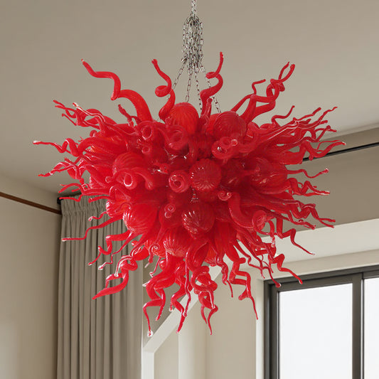 Close-up detail of the swirling red hand blown art glass elements of a contemporary chandelier.