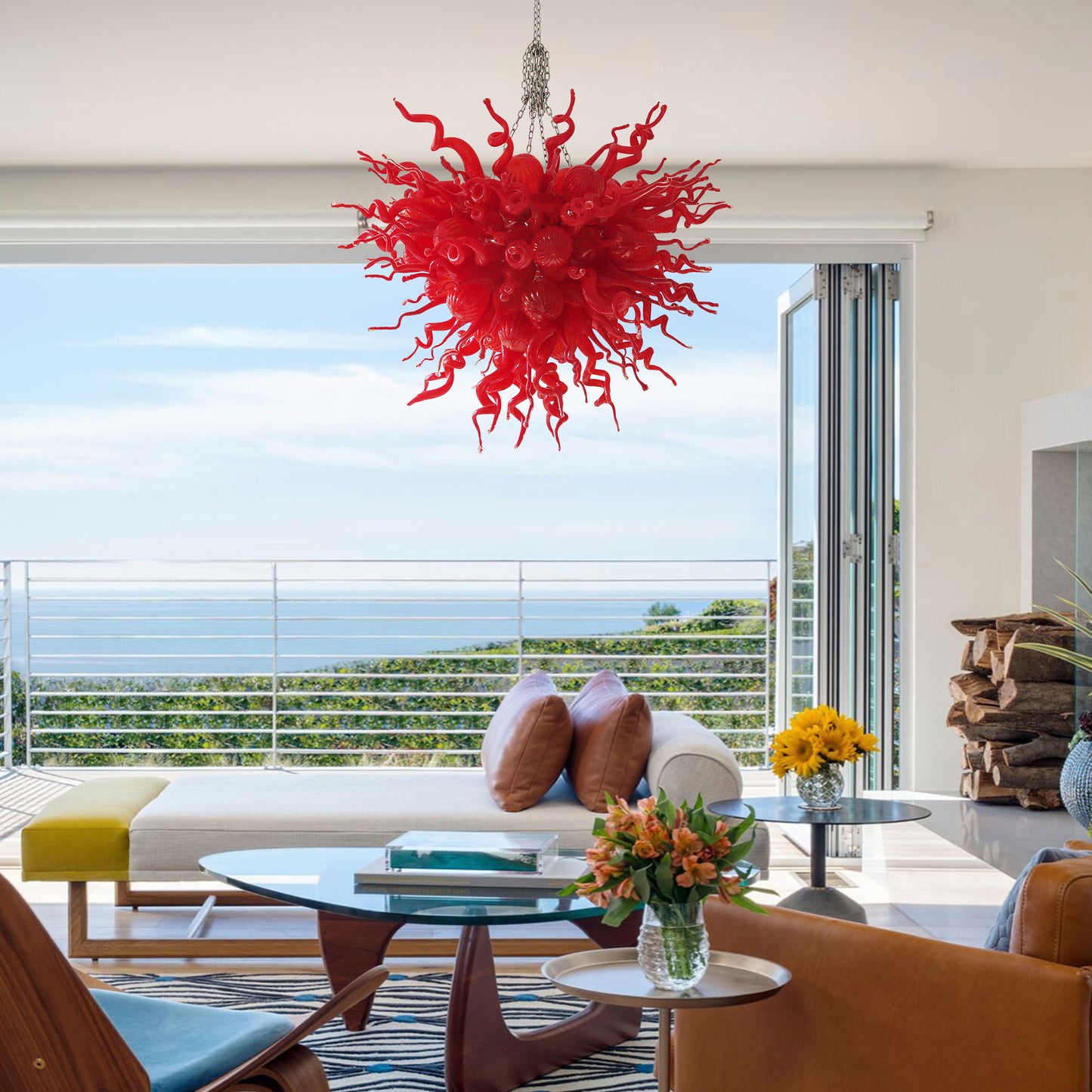 Large red hand blown art glass chandelier providing a dramatic focal point in a living area.