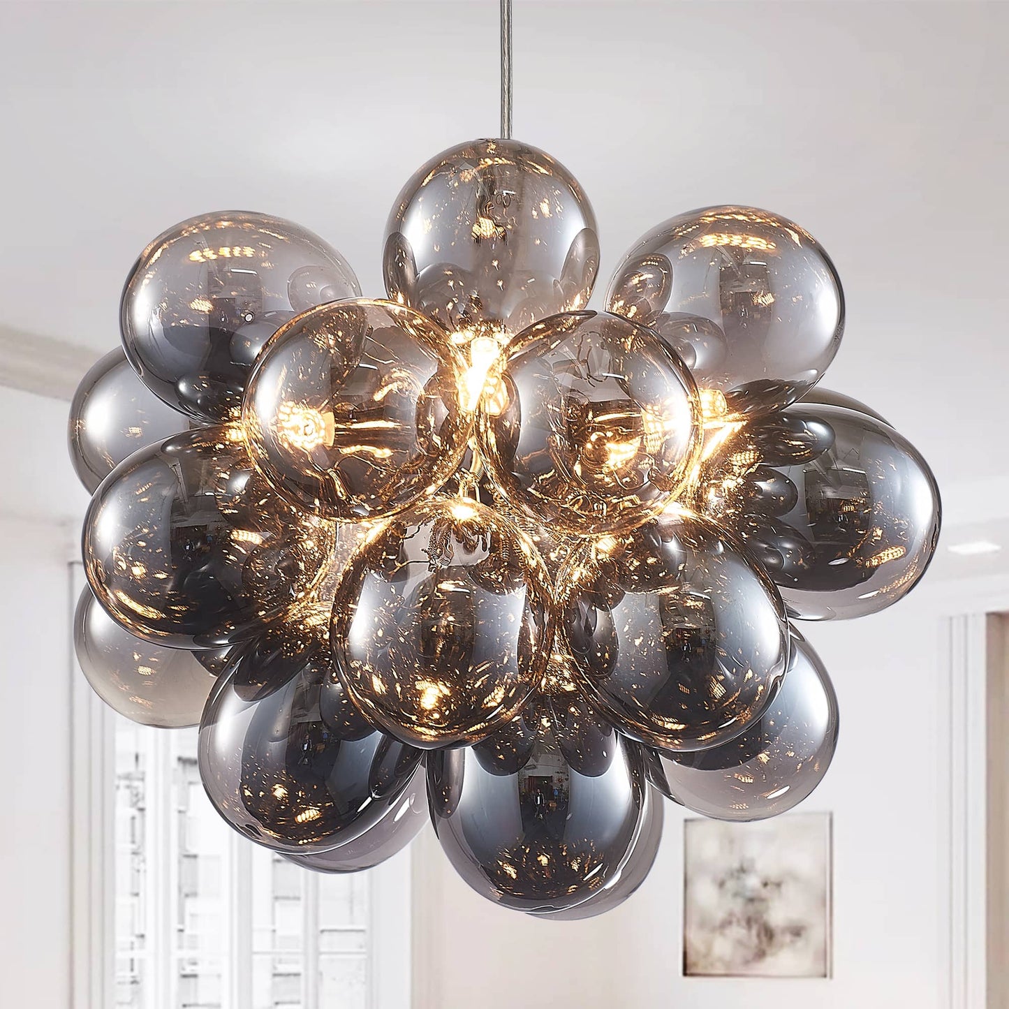 Front and side views of the Obsidian Gloom blown glass chandelier, highlighting the symmetrical sphere shape and metallic electroplating craftsmanship.
