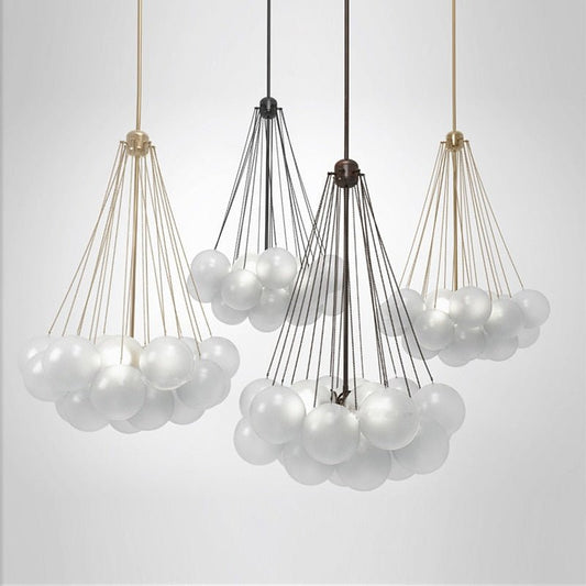 Four frosted glass globe pendants in gold and black finishes showcasing different cluster sizes.