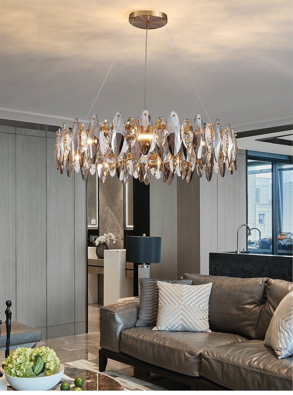 Modern luxury diamond shape crystal chandelier with gold circular frame in a living room.
