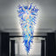 Giant blue and white hand-blown glass chandelier in a dramatic inverted cone shape, shown in a modern interior setting.