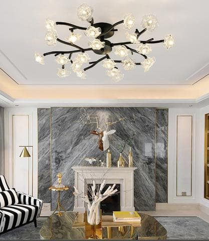 Luxurious LED crystal flower ceiling light mounted against a gray marble wall.