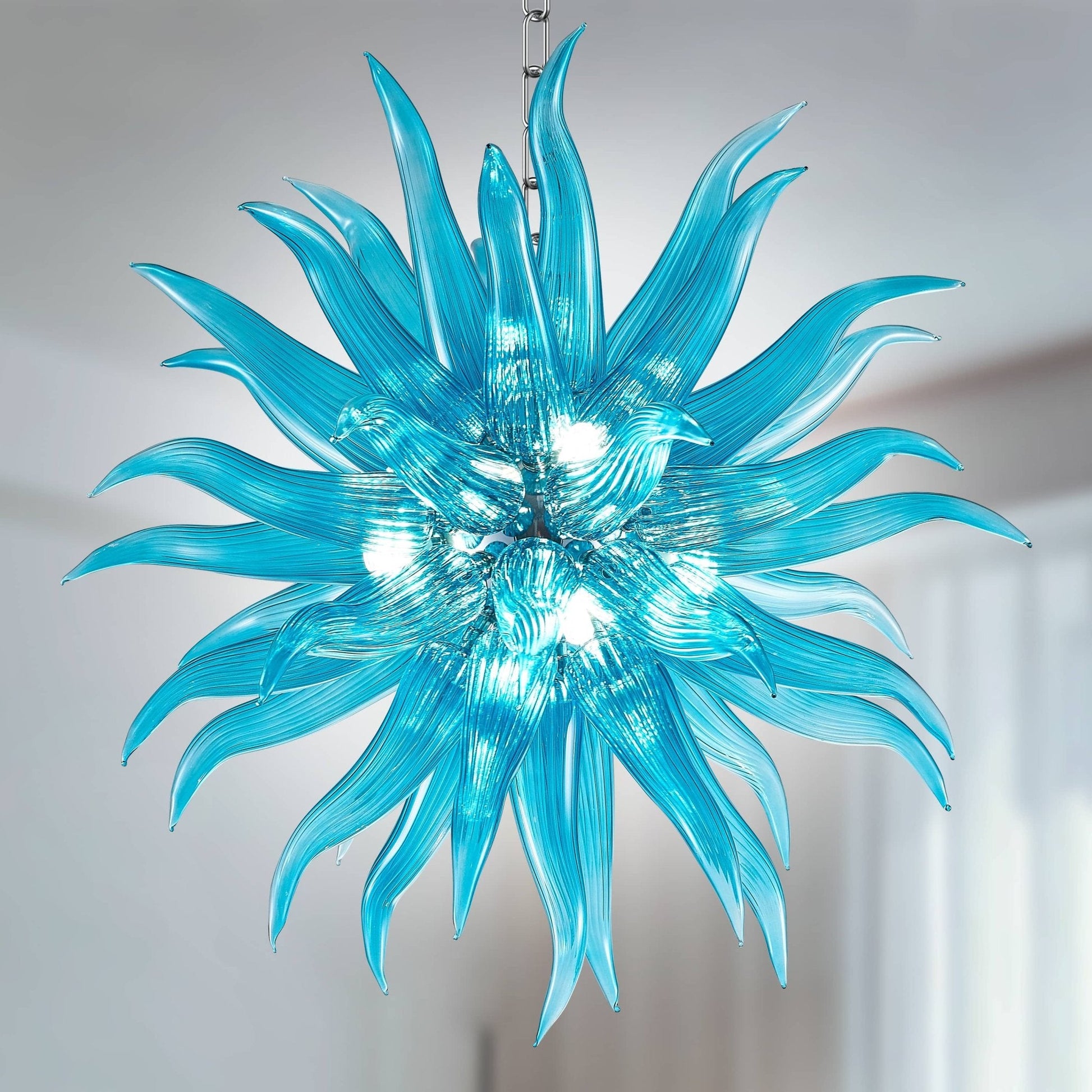 Azure Starburst blown glass chandelier featuring a dense arrangement of hand-blown ice-blue tapered glass elements.