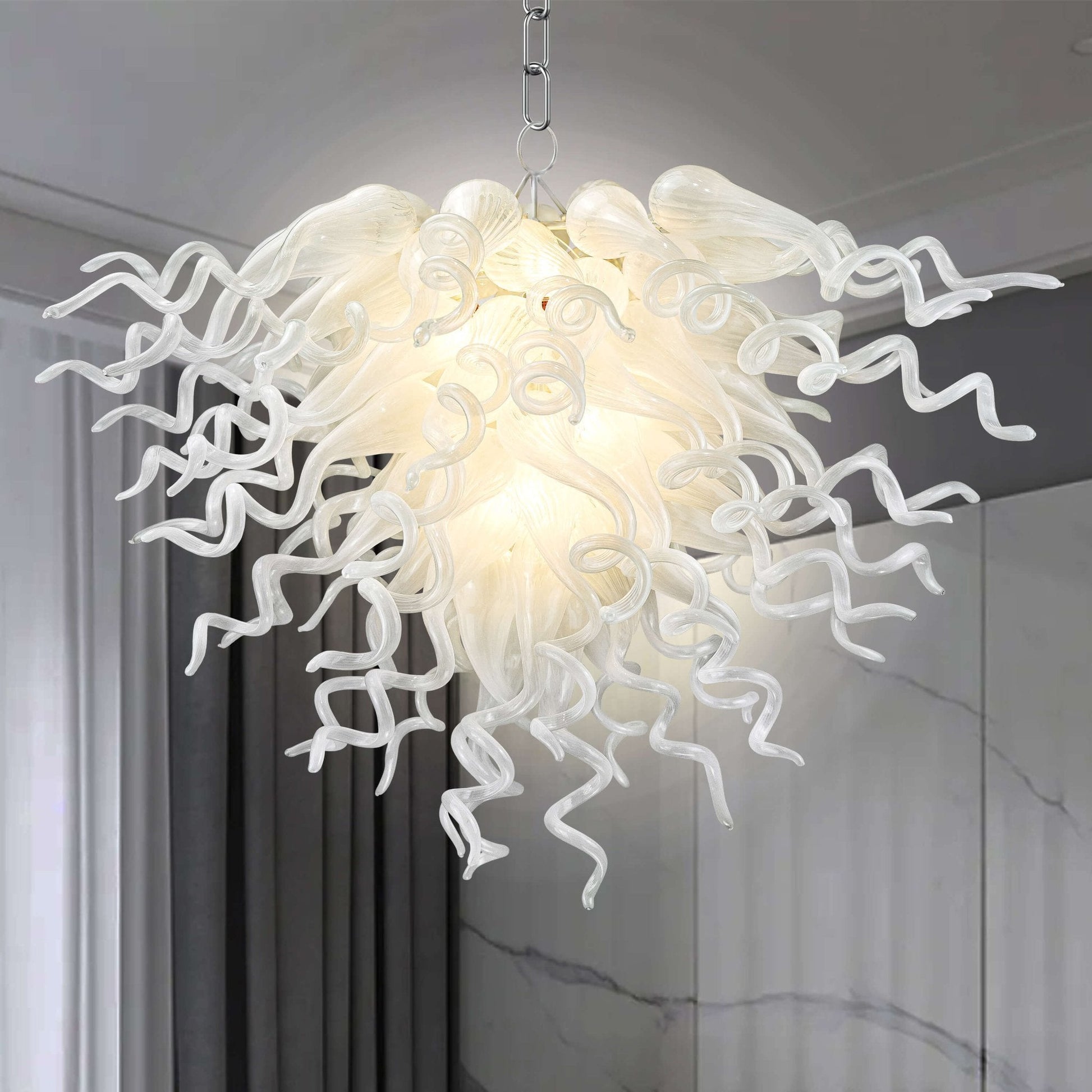 Detailed view of a pearl white artisan blown glass chandelier featuring dense, twisted glass tendrils with a lustrous finish.