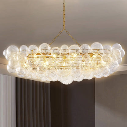 Close-up of Linear Bubbles Chandelier in Talia style with spiral ribbed clear glass globes and antique brass frame.