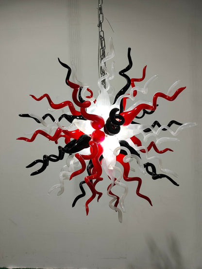 Modern chandelier with red, black, and white design on a plain background