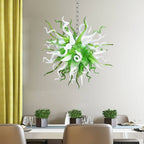 Modern green and white glass art chandelier providing a fresh accent in a bright dining room with neutral decor.