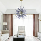 Luxury smoky glass chandelier illuminating a bright, high-ceiling entryway with elegant floor-to-ceiling curtains.