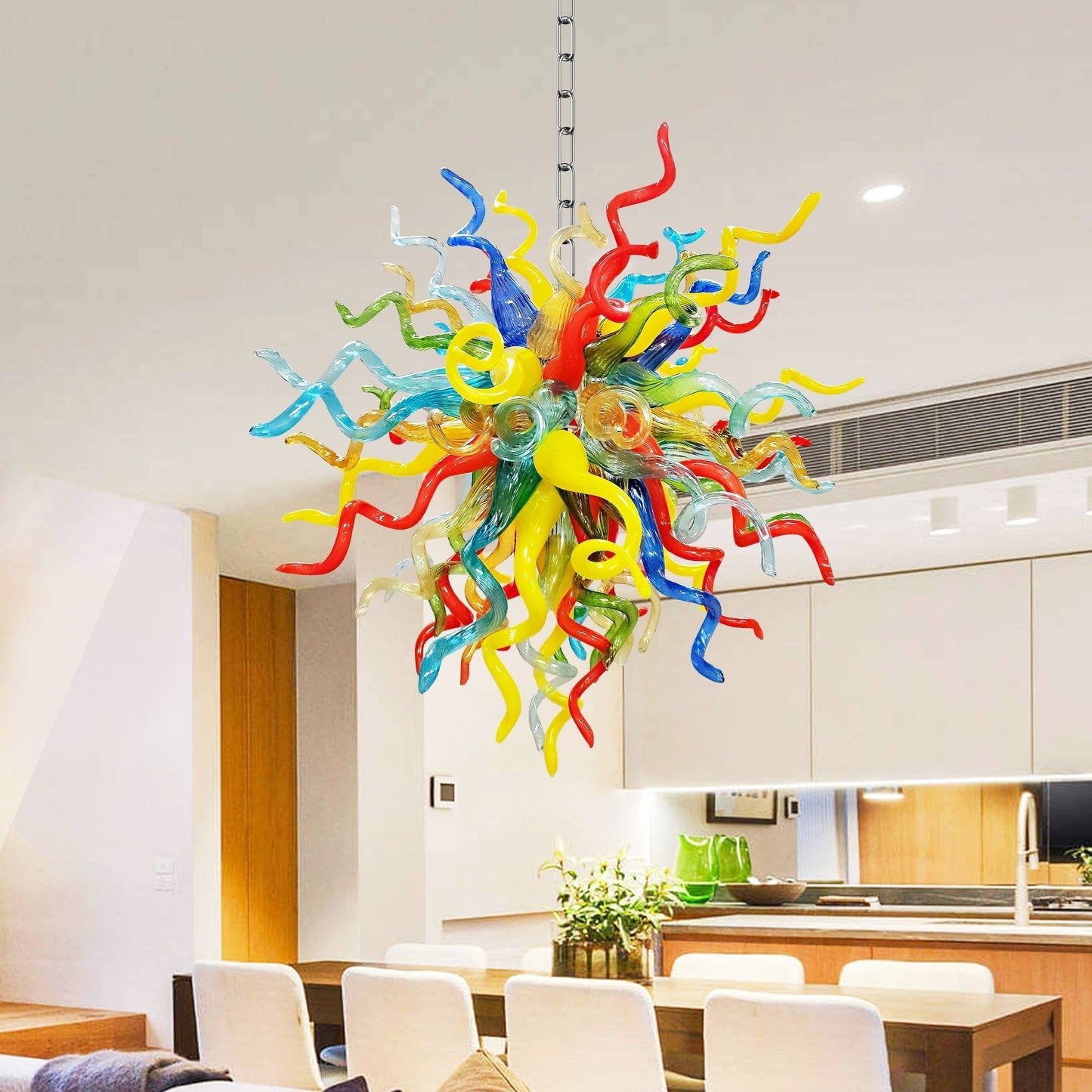 Colorful blown glass chandelier hanging in a modern kitchen
