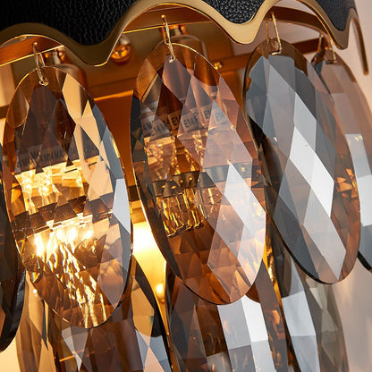 High-quality faceted crystal droplets on gold-plated metal wall light fixture.