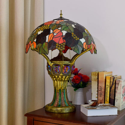 Vintage table lamp with glowing base and colorful leaf pattern