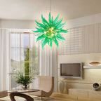 Veridian green glass chandelier creating a warm and inviting atmosphere in a sophisticated lounge area.