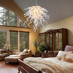 Cozy upscale bedroom interior with warm wooden accents and a white sculptural glass chandelier hanging above the bed.