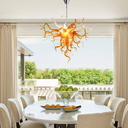 Amber and clear Chihuly-style hand blown glass chandelier in elegant dining room.