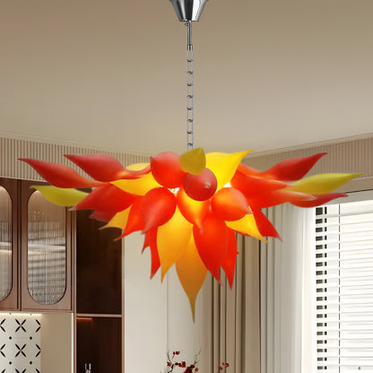 Red-orange petal details on nature-inspired blown glass chandelier.