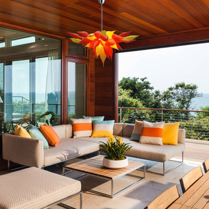 Nature-inspired flower blown glass chandelier in modern outdoor living space.