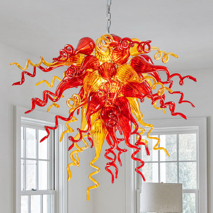 Red and Yellow Hand Blown Art Glass Chandelier hanging in a bright, modern room.