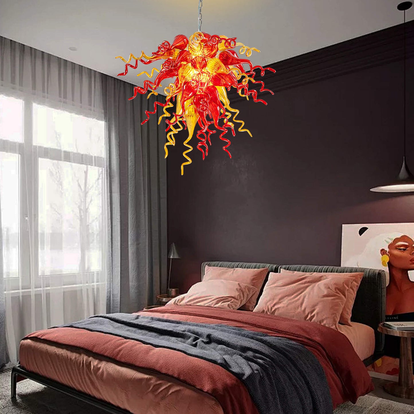 Elegant red and yellow hand blown art glass chandelier hangs in the warm-toned bedroom.