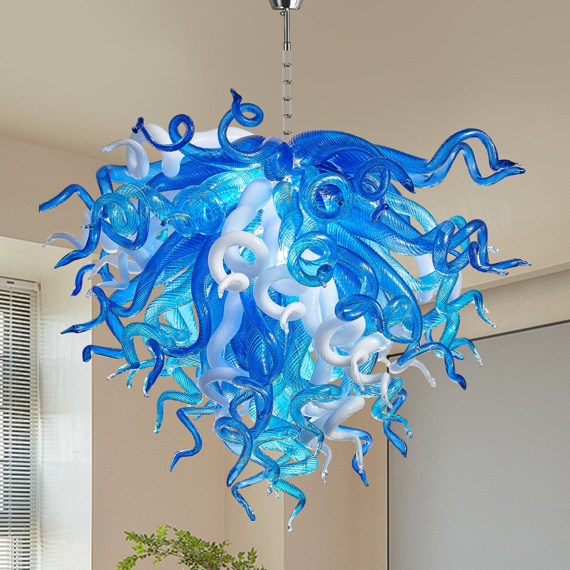 Blue and white Murano inspired blown glass chandelier against a cream wall background.