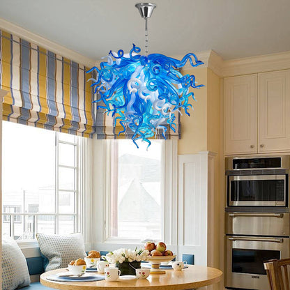 Chihuly-inspired blue and white murano blown glass chandelier, warm glow in dining space.