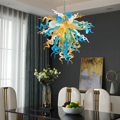 Dining room space featuring a stunning blue, gold, and white hand blown glass art chandelier.