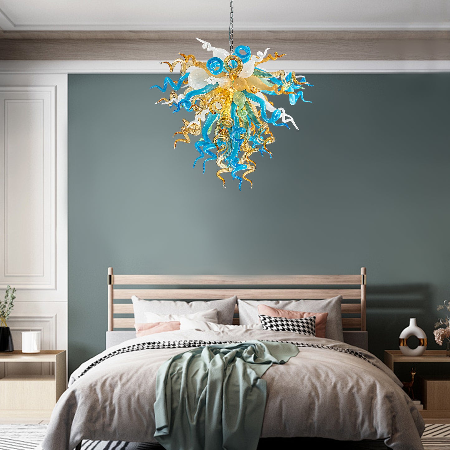 Modern blue and gold hand blown glass chandelier creating a sophisticated ambiance in bedroom.