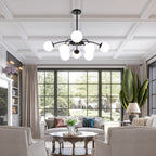 Modern black 8-light frosted glass bubble globe chandelier in dining room with outdoor garden view.