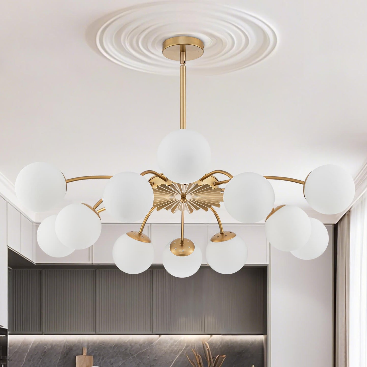  Brightly lit 12-light gold rod Chandelier with frosted opal glass globes, showcasing the adjustable hanging style.