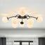Contemporary black 8-light globe semi-flush mount ceiling light in airy living room.