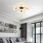 8-Light black ball semi-flush mount ceiling light in modern living room with dark curtains.