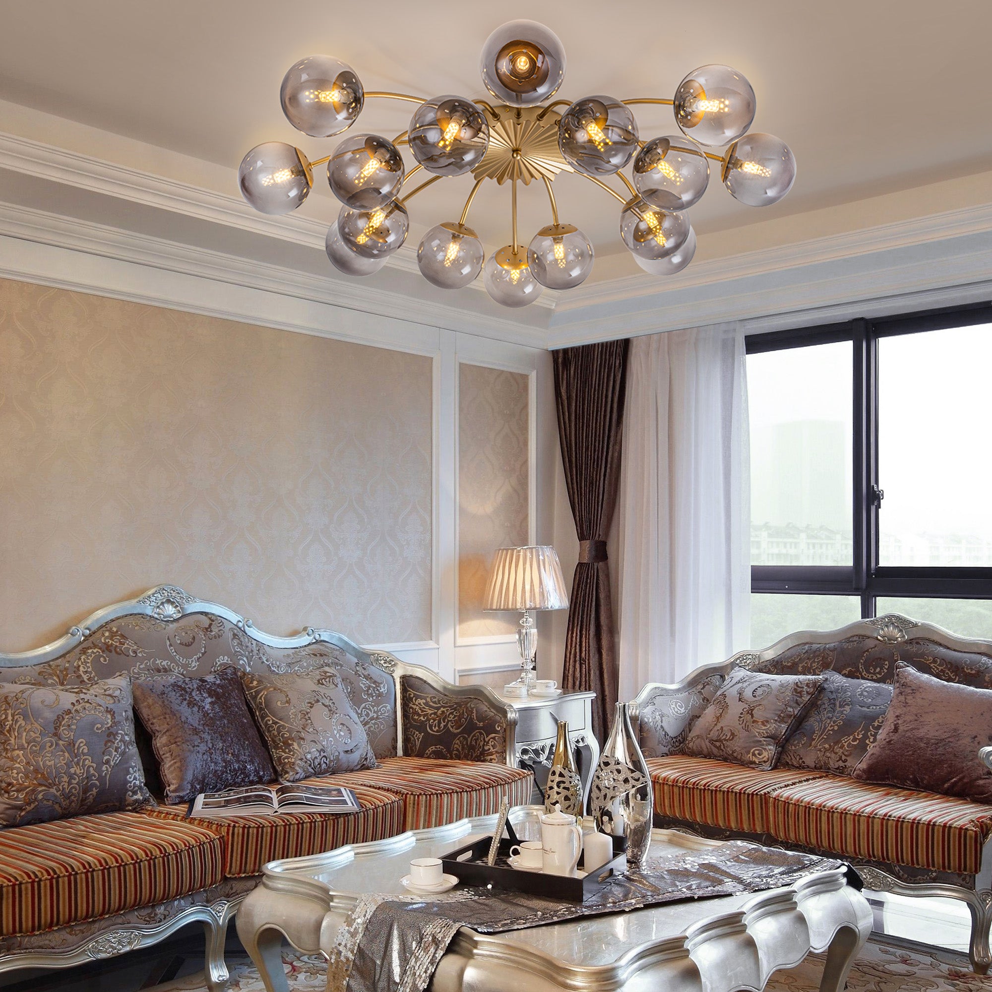 Smoky gray glass globe ceiling light fixture in classic living room with ornate sofa & patterned walls.