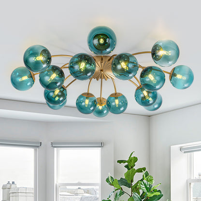 16-Light teal glass bubble globe ceiling light in bright living room with large windows.