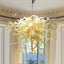 Chihuly-style amber hand blown murano glass chandelier in a formal living or dining room with high ceilings.