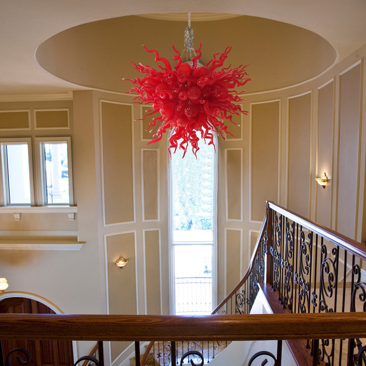 Red abstract hand blown glass sculpture functioning as a grand art chandelier in a luxury home.