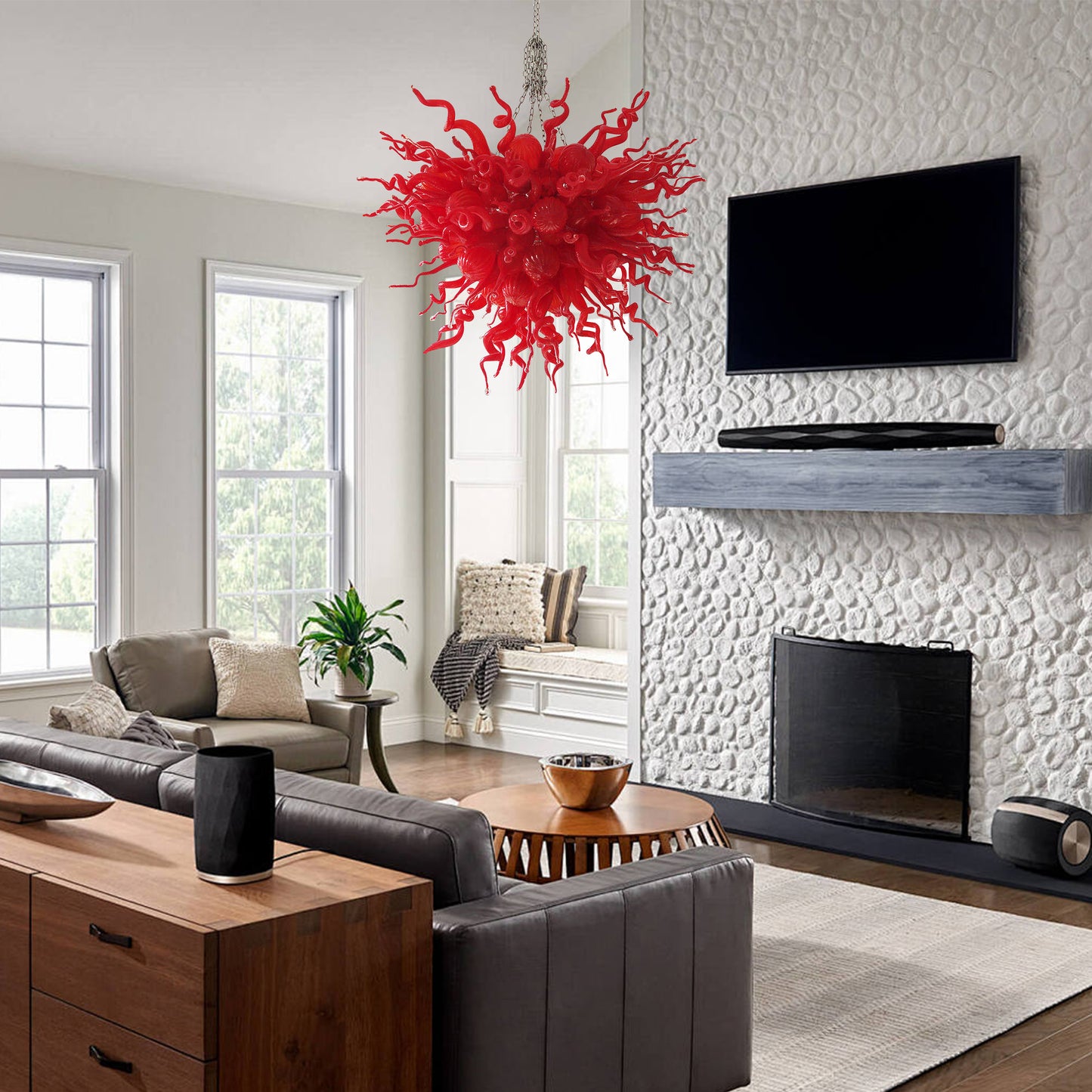 Vibrant red hand blown art glass chandelier over a modern living room.