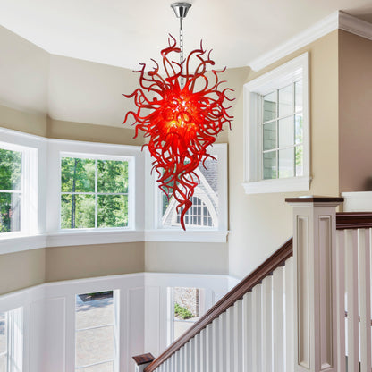 Fiery red Chihuly-style hand blown glass chandelier in arched-entry foyer.