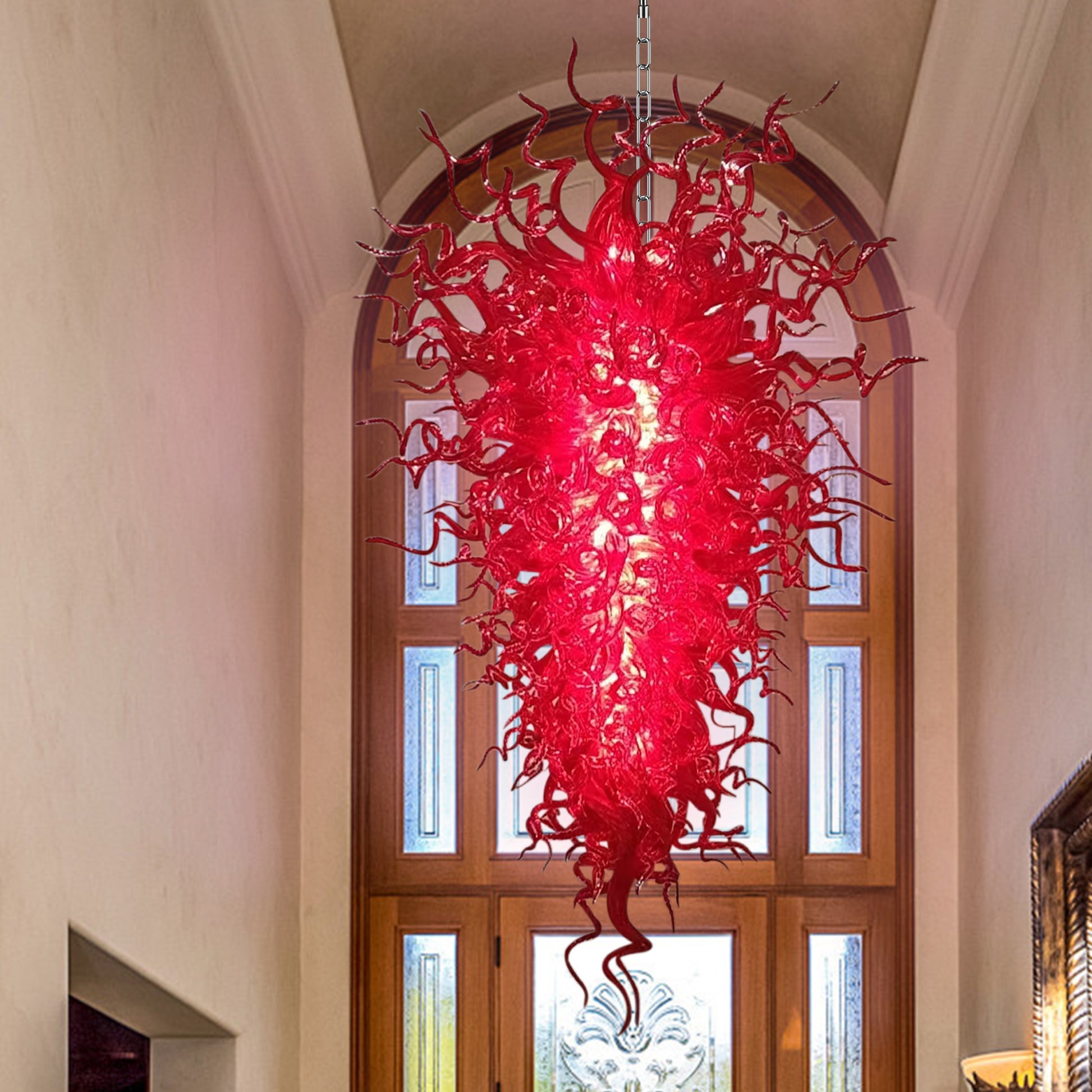 Crimson murano blown glass chandelier as a dramatic focal point in a traditional home entryway.