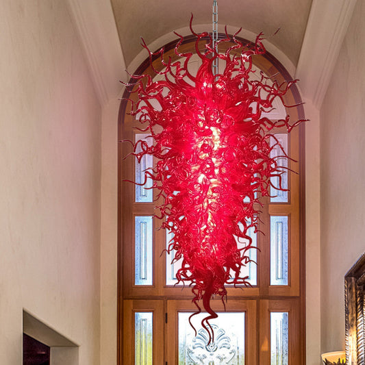 Crimson murano blown glass chandelier as a dramatic focal point in a traditional home entryway.