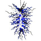 Isolated studio shot of the midnight nebula chandelier highlighting the intricate mix of blue, black, and white glass tendrils.