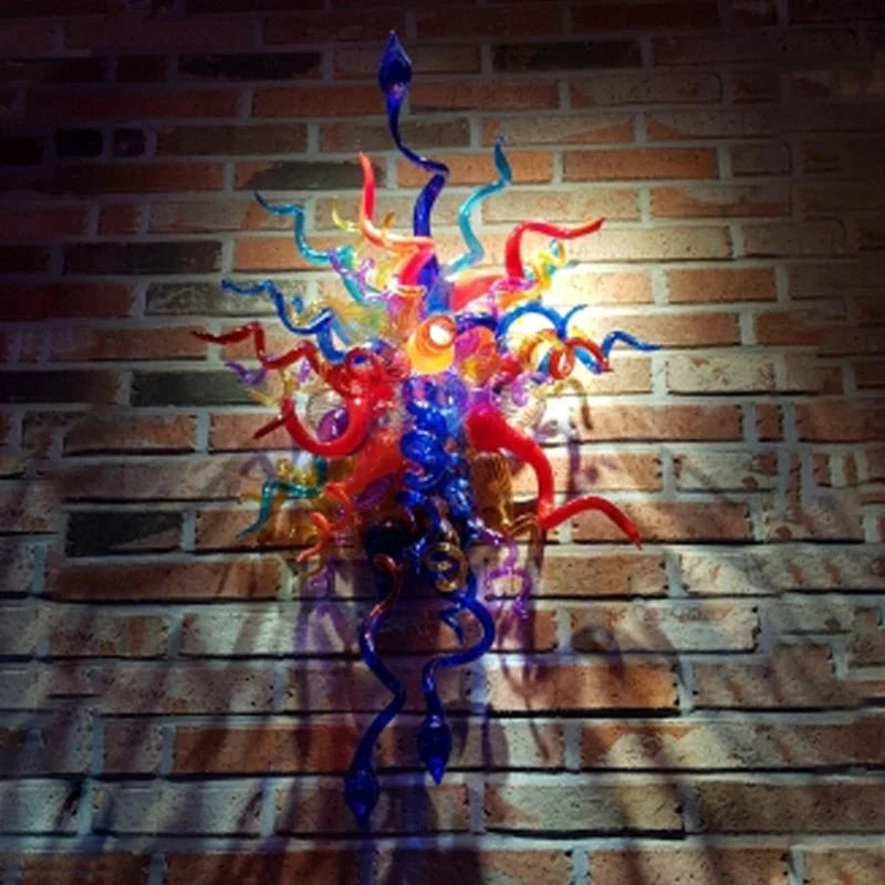 Blue and purple art glass wall installation showcased against a rustic brick wall for a loft-style aesthetic.