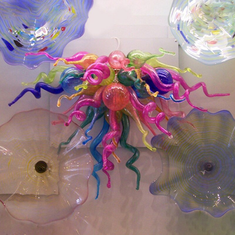 Whimsical pink, purple, and teal blown glass wall sculpture for creative and playful interior spaces.