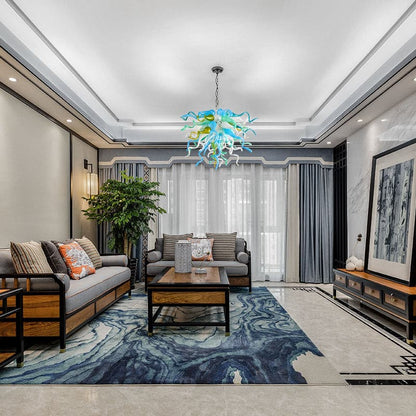 High-ceiling interior with a grand sky blue and jade green hand-blown glass pendant light as a central artistic statement.