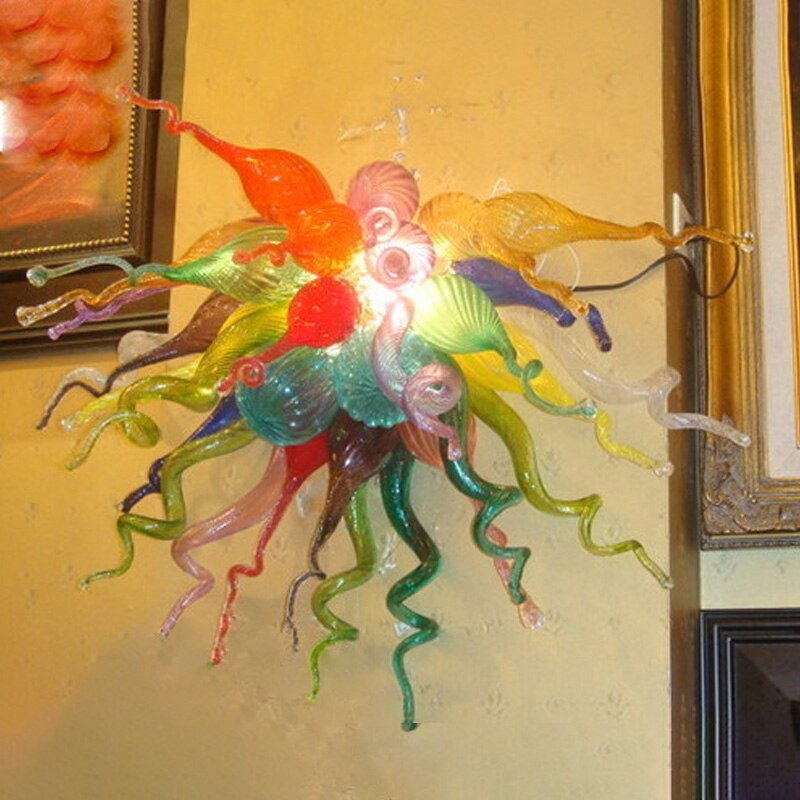 Close-up of a multicolored glass wall light installation in a bright, modern hallway.