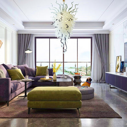 Contemporary designer living room with a purple sofa and green ottoman, featuring the black and white sculptural glass chandelier as a sophisticated ceiling focal point.