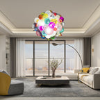 Modern living room with a large floor-to-ceiling window and a vibrant multi-color glass sculpture chandelier hanging as a focal point.