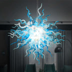 Chihuly chandelier with blue and white  blown glass design in a dark room