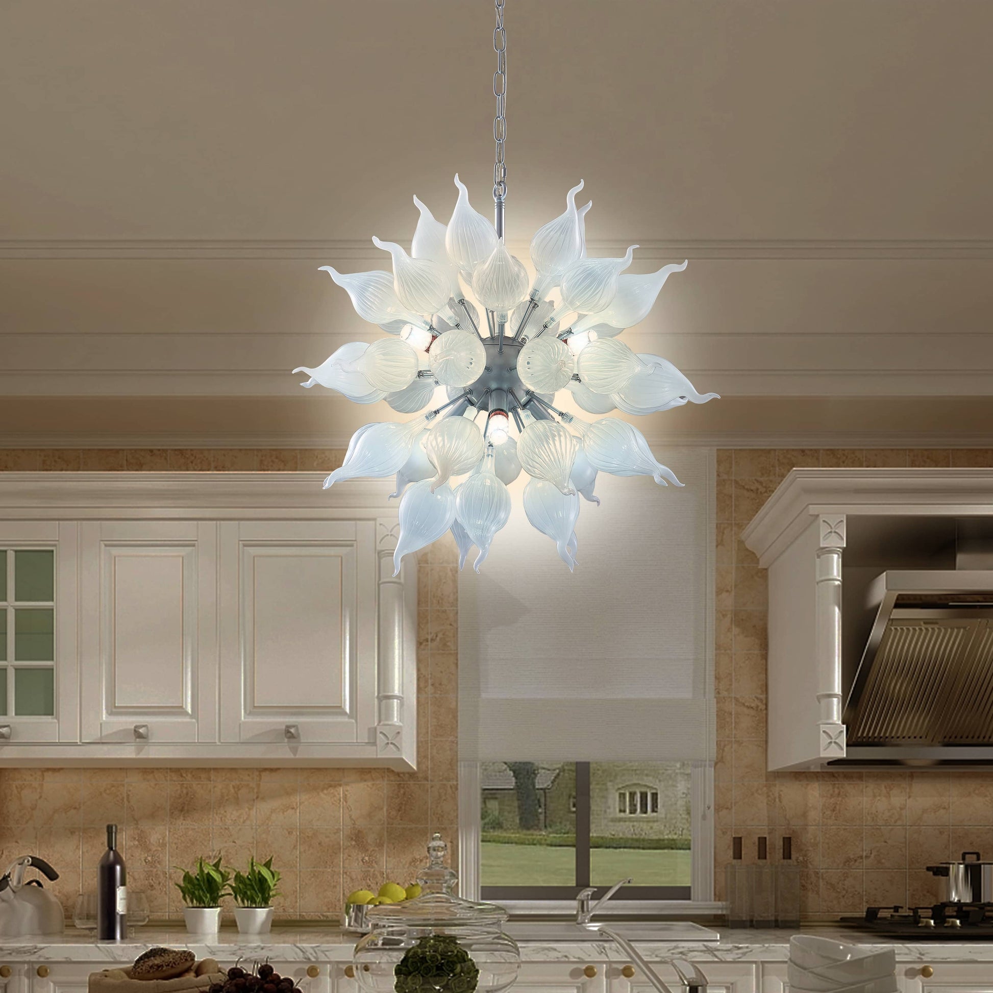 Modern and contemporary chandelier hanging in a kitchen with white cabinets and a neutral color scheme.